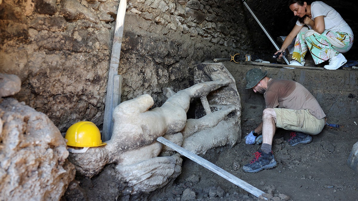 Statue of Greek god uncovered by archaeologists during excavation of ancient Roman sewer in Bulgaria