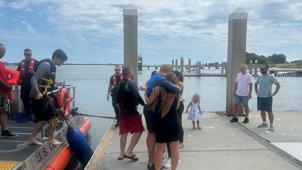 Coast Guard rescues 5 men huddled atop capsized boat 11 miles off Florida coast