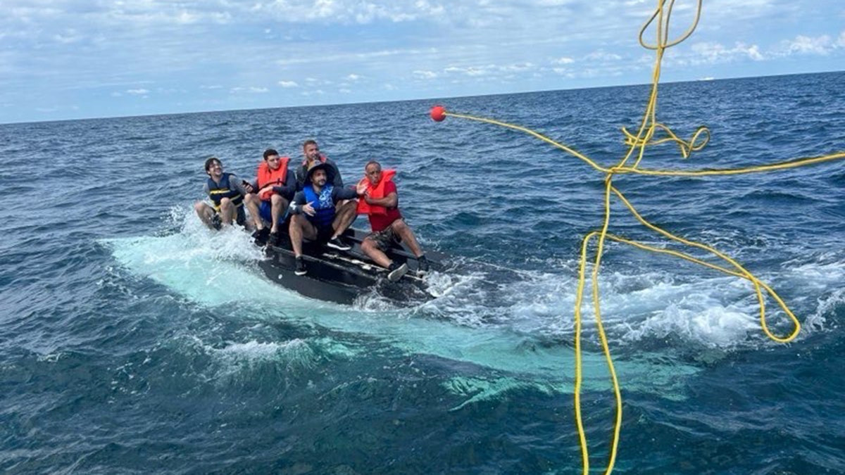Coast Guard rescues 5 men huddled atop capsized boat 11 miles off Florida coast